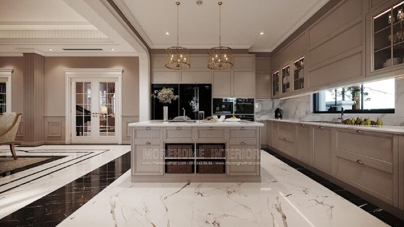 Bàn đảo bếp tân cổ điển ốp đá đẹp sang trọng với thiết kế nhiều hộc tủ cùng các ô mở giúp không gian trở nên linh động, tiện nghi. Đá ốp bàn đảo bếp biệt thự