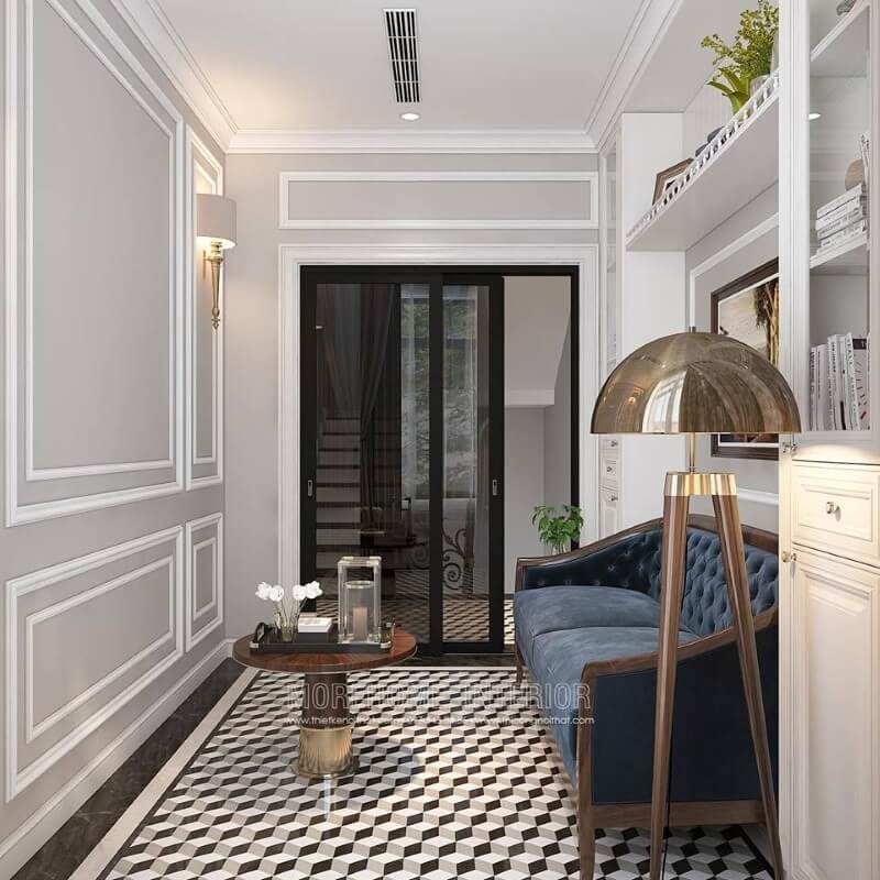 Gạch lát nền giả cổ, sofa văng gỗ óc chó tân cổ điển bọc nệm xanh cùng tường trắng đơn sắc đã tạo nên không gian đẹp sang trọng, đáp ứng tối đa công năng cho phòng đọc sách.